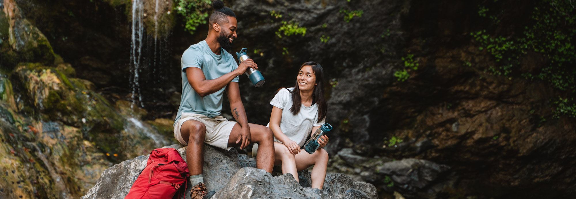man and women drinking from RapidPure water bottle
