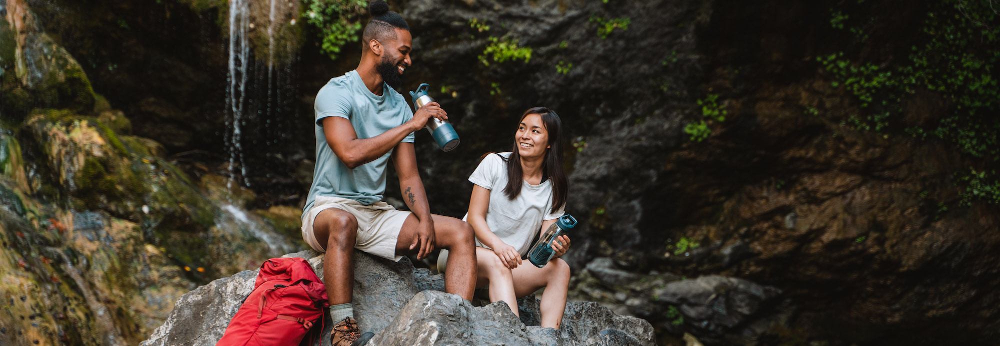 man and women drinking from RapidPure water bottle 