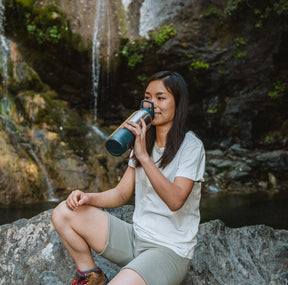 Woman drinking from RapidPure insulated bottle